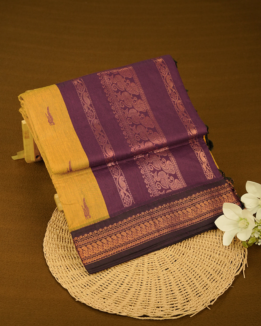 Mustard Yelow colour kalyani cotton saree featuring Grape Colour Peacock pattern on body, complemented by Grape with Grand Copper Zari border, paired with matching blouse piece