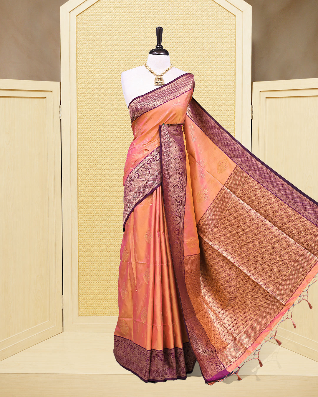 Peach & gold double shade Mulberry silk saree featuring floral gold zari patterns on body, paired with contrast purple colour with traditional border, comes with matching blouse piece.