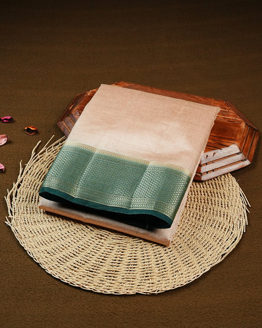 Cream colour Tussar silk saree Featuring Elegant Plain body, complemented by Contrast dark green colour with gold zari border, paired with matching blouse piece.