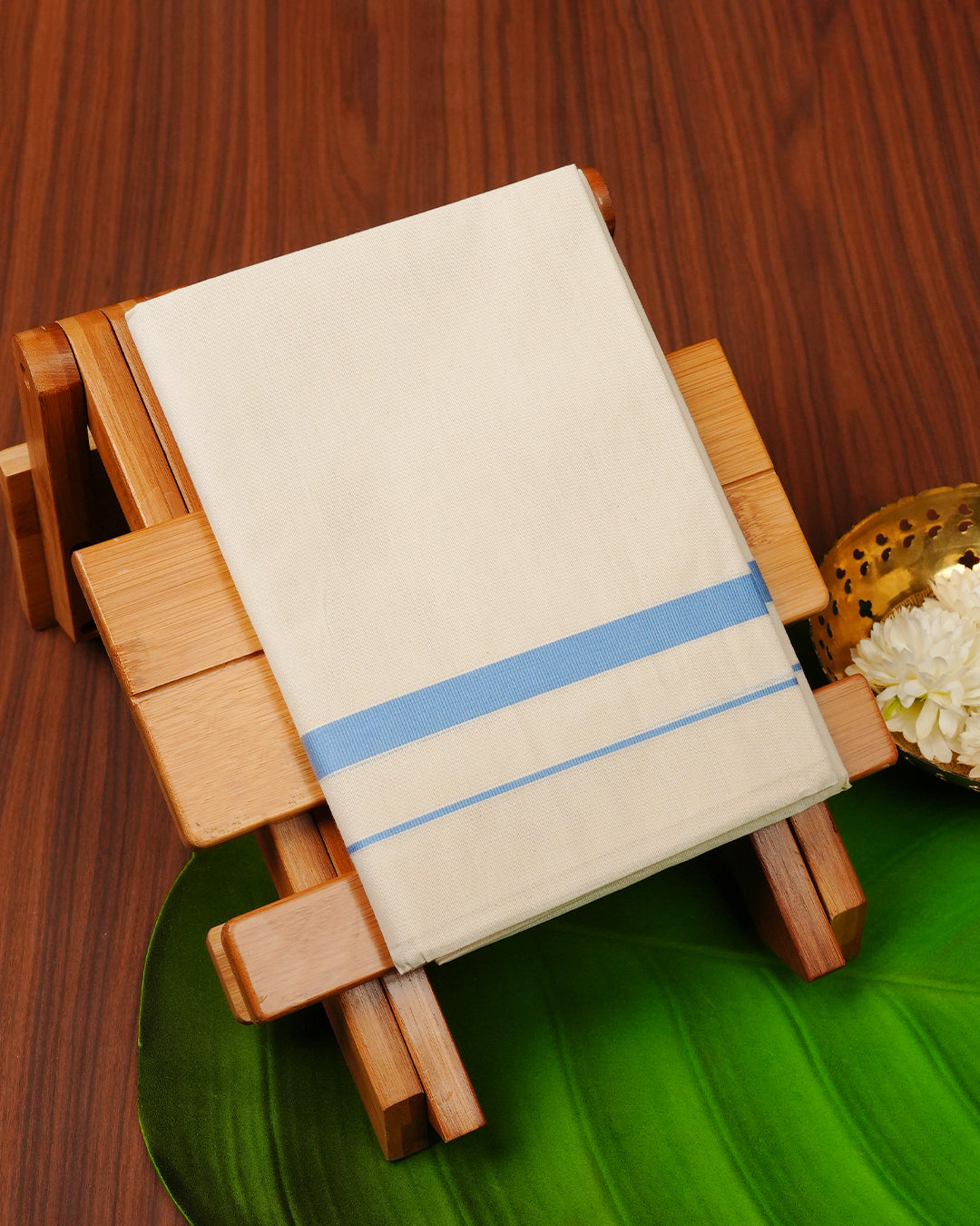 Cream colour cotton single dhoti featuring Light blue colour border.
