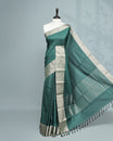 Green colour saree featuring a plain body, complemented by a Bavanchi border and contrast pallu, paired with a matching blouse piece.