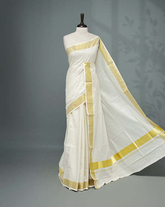 Cream colour Kerala saree Featuring Gold zari stripes on the body, complemented by a classic gold zari border, matching blouse piece.