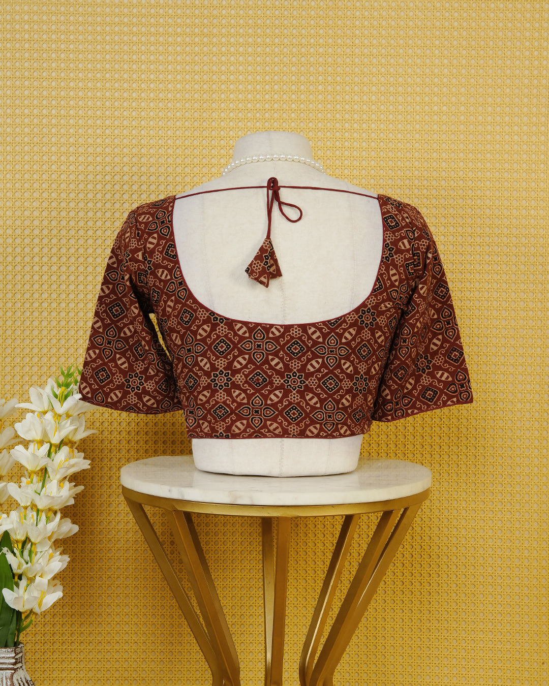 Maroon Colour Blouse Featuring A Classic U-Neck, Intricate Geometric Printed Design, And Comfortable Elbow Length Sleeves.