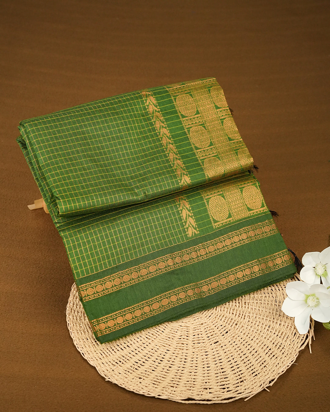 Green colour kalyani cotton saree featuring zari check pattern on body, complemented by Contrast colour with Antique zari border, paired with matching blouse piece