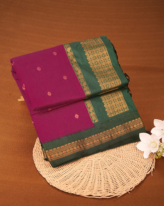 Magenta colour kalyani cotton saree featuring gold zari Floral pattern on body, complemented by Green colour with Gold zari border, paired with matching blouse piece