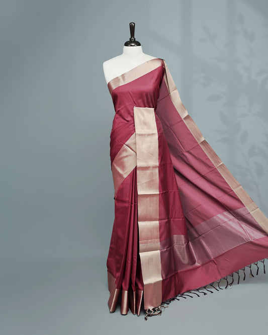 Maroon colour saree featuring a plain body, complemented by a Bavanchi border and contrast pallu, paired with a matching blouse piece.