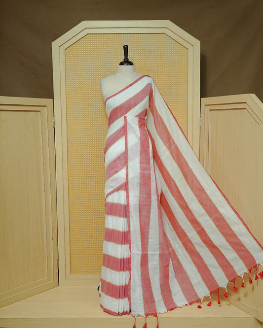 Off White & Red Striped Mul Cotton Saree featuring broad alternating white and Red Stripes, subtle zari detailing, and Finished With red tassels.