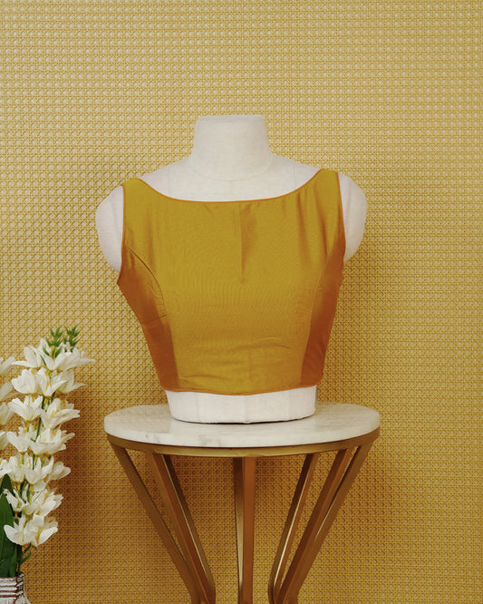Mustard Colour Sleeveless Blouse Featuring A Classic Boat Neck, Smooth Finish, And A Comfortable Tailored Fit.