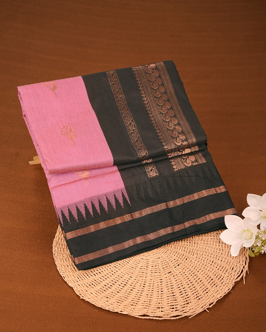Pink Colour Kalyani cotton saree featuring elegant antique zari peacock butta motifs on the body, complemented by a Black contrast pallu with a rich antique zari border, paired with a matching blouse piece