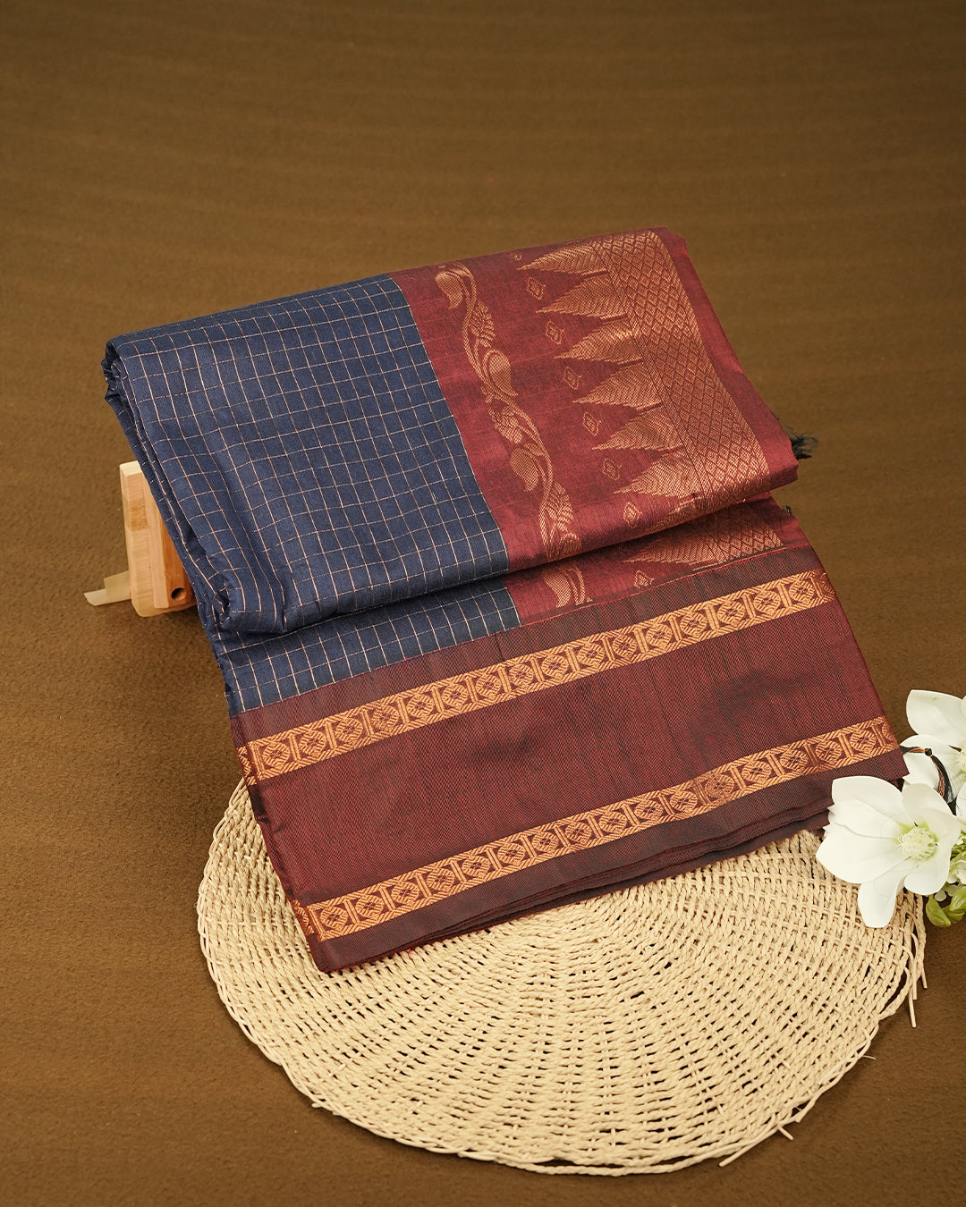 Navy Blue colour kalyani cotton saree featuring Copper zari check pattern on body, complemented by Maroon colour with Antique zari border, paired with matching blouse piece