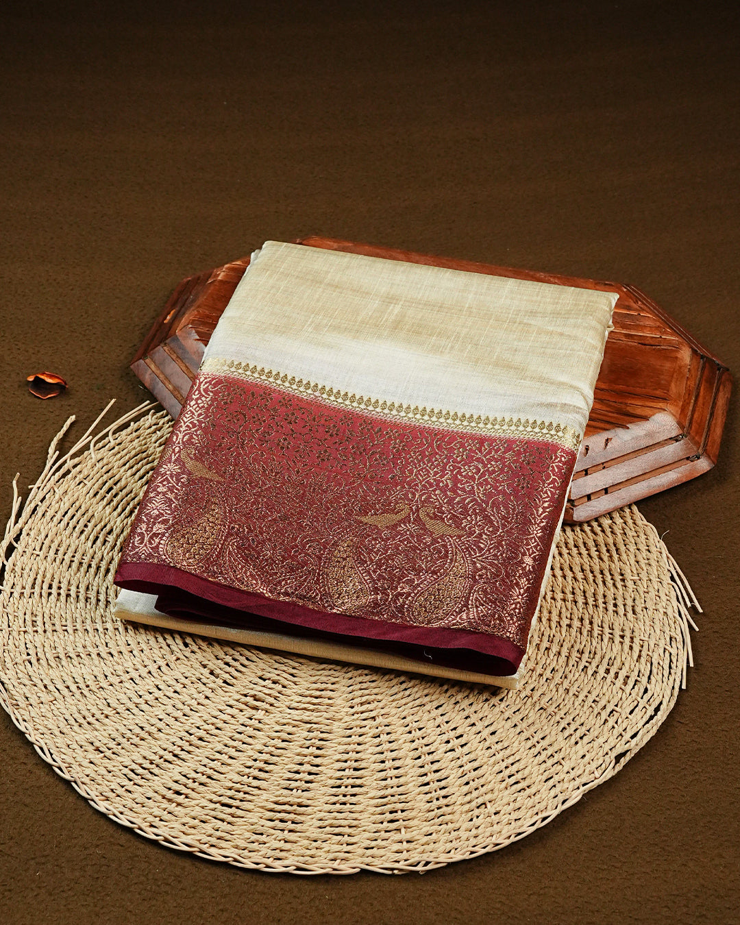 Light gold tussar saree featuring Elegant plain body, complemented by contrast Maroon colour with Gold zari Floral kodi with Peacock Pattern border, comes with matching blouse piece.