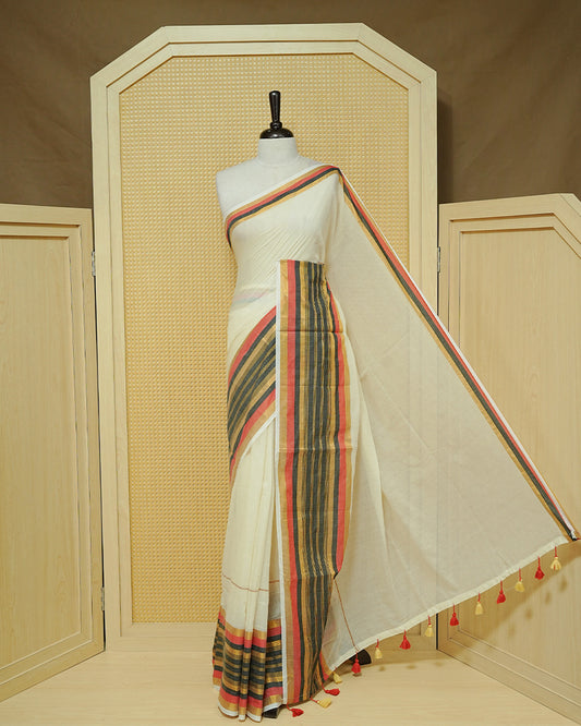 Cream colour Mul cotton saree featuring Elegant Plain body, complemented by contrast Red, Black & gold zari border & Tassels.