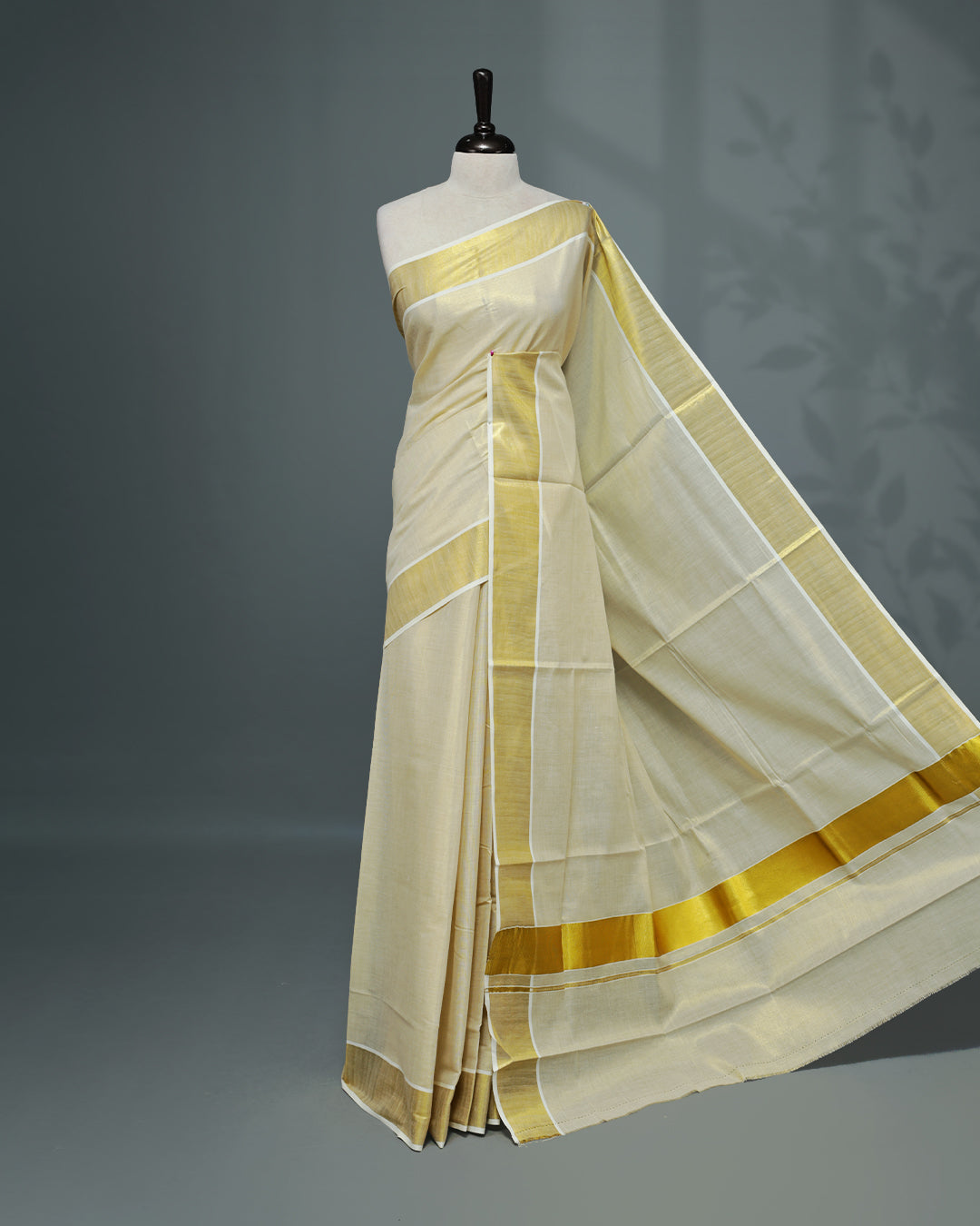 Cream colour Tissue Kerala saree Featuring An Elegant plain body, complemented by a classic gold zari border, matching blouse piece.