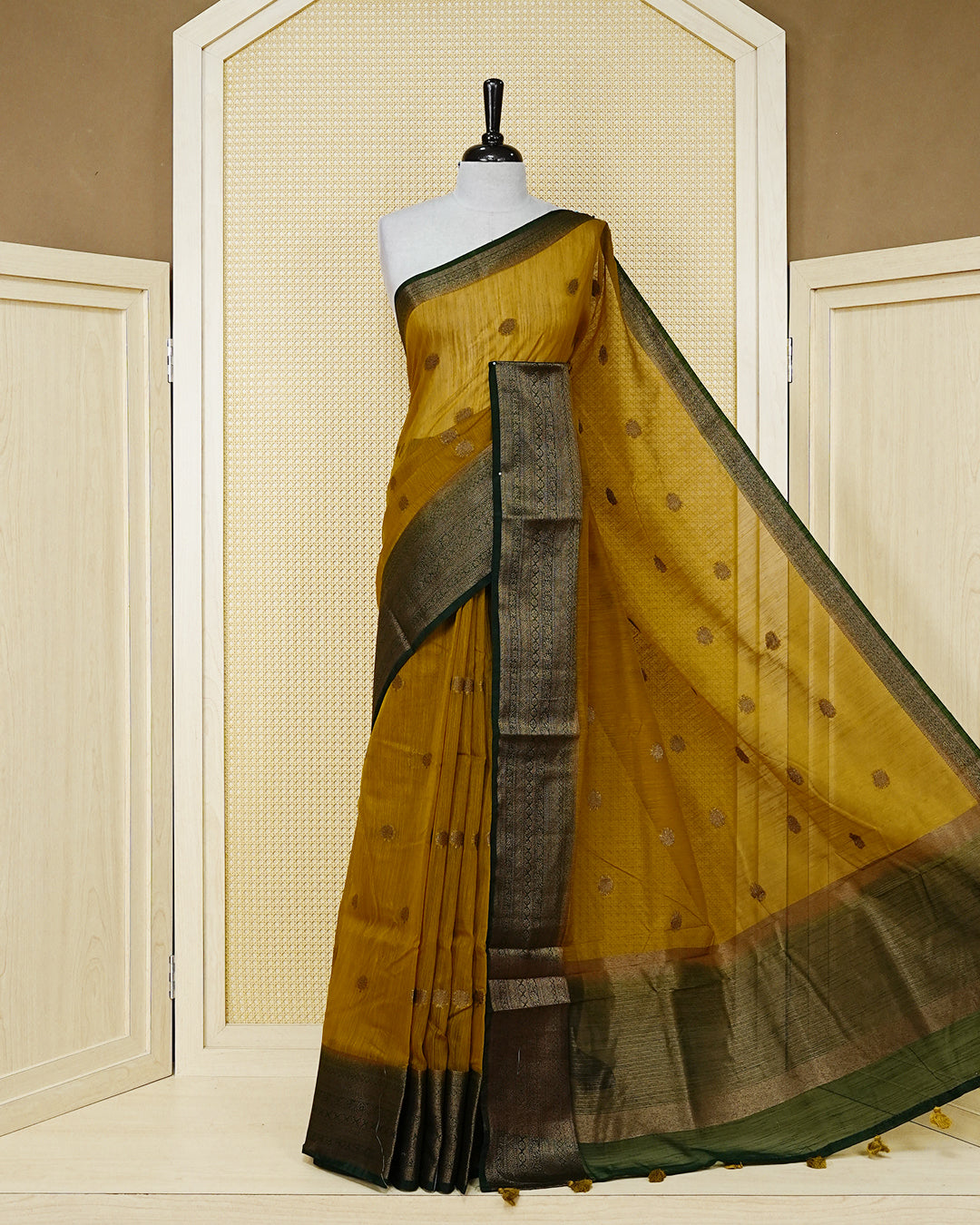 Mustard yellow colour semi linen saree thread motifs on body, contrast Dark green colour gold zari border, rich pallu comes with matching blouse piece