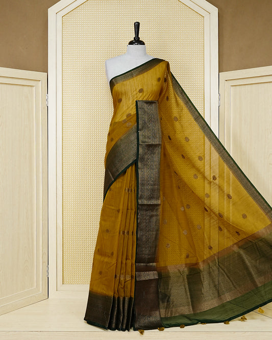 Mustard yellow colour semi linen saree thread motifs on body, contrast Dark green colour gold zari border, rich pallu comes with matching blouse piece