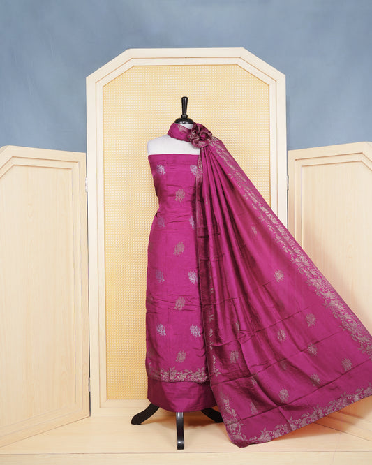 Magenta Pink Silk Salwar Matirial Features an Elegant Floral Embroidary Pattern Aborned With Simmering Metalic Thread Work, Paired with matching bottom & elegant Dupatta