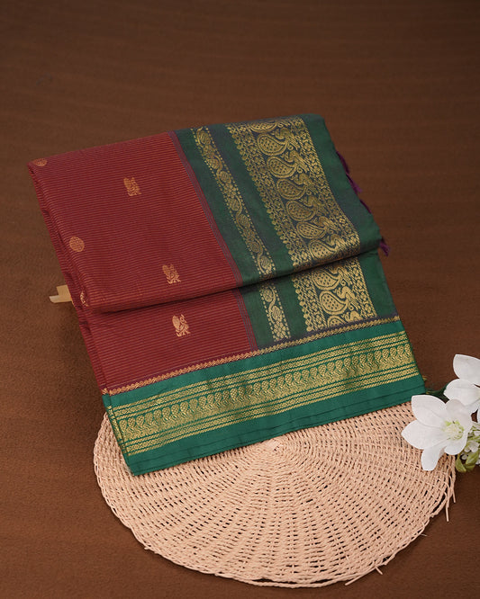 Maroon colour kalyani cotton saree featuring gold zari Stripes on body, complemented by Green colour with Antique zari border, paired with matching blouse piece
