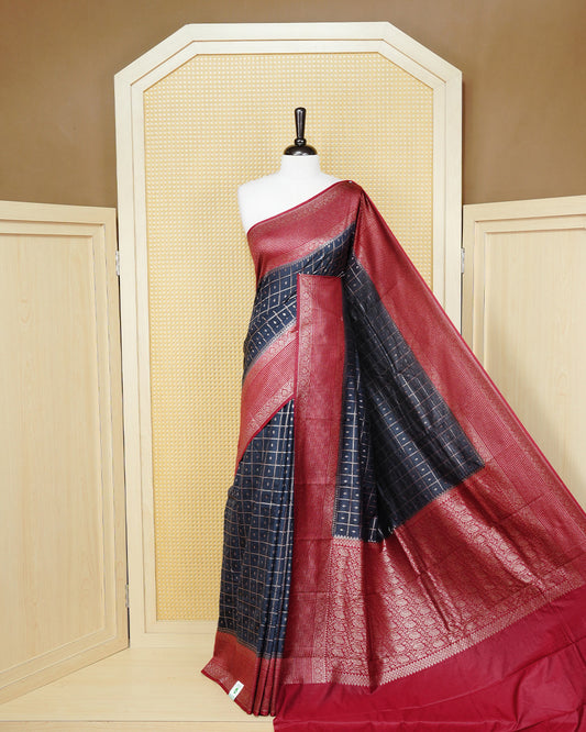 Navy blue Colour Semi georgette Saree having zari check with buttas pattern on body, contrast maroon colour floral designed border, Rich Pallu comes with Matching Blouse piece.
