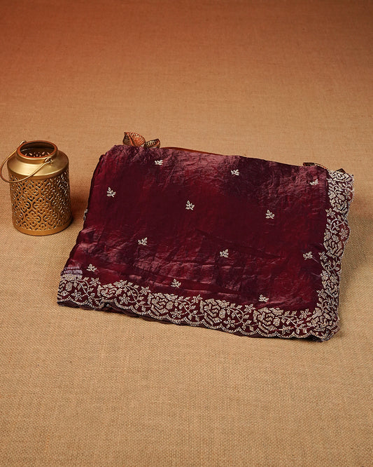 Maroon colour Velvet chiffon designer saree featuring delicate stone motifs on body and stone worked border, comes with matching blouse piece.
