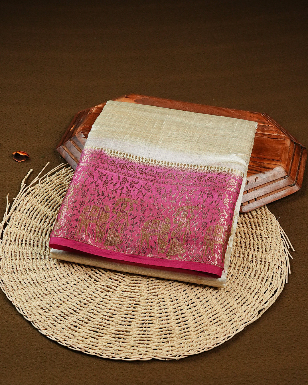 Light gold tussar saree featuring Elegant plain body, complemented by contrast Magenta colour with Gold zari Floral kodi with Elephant Pattern border, comes with matching blouse piece.