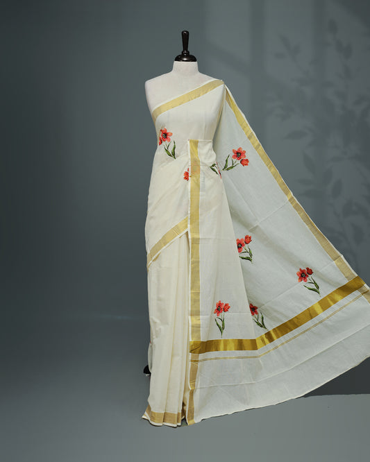 Cream colour Cotton kerala saree featuring floral Print with thread work on the body, complemented by a gold zari Border, paired with a matching blouse piece.