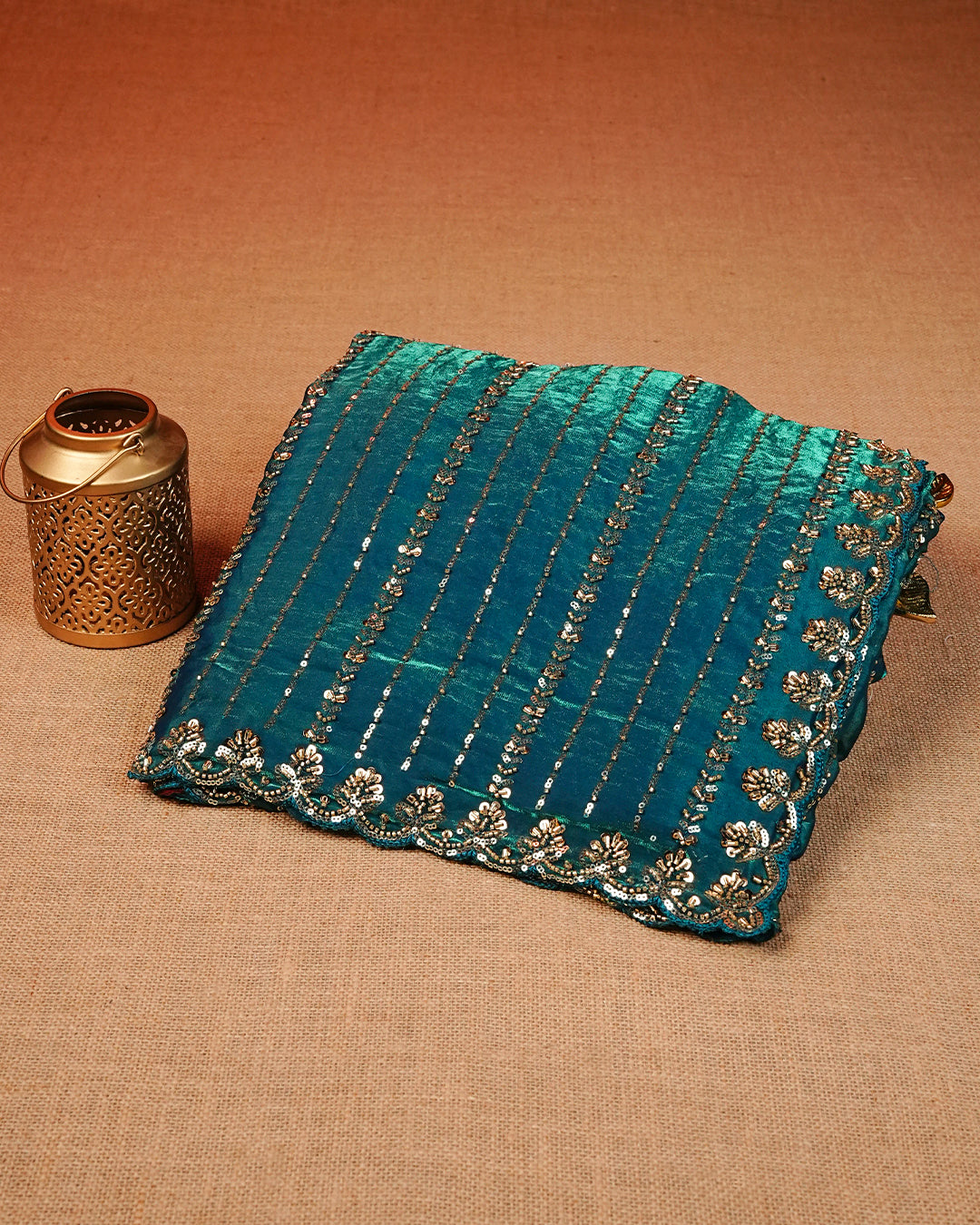 Teal colour Velvet chiffon designer saree featuring Sequins & cut beats strips on body and scallop border, comes with matching blouse piece.