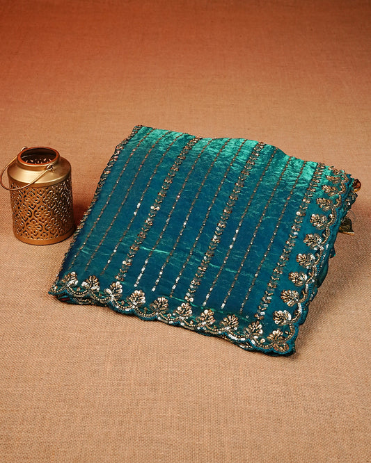 Teal colour Velvet chiffon designer saree featuring Sequins & cut beats strips on body and scallop border, comes with matching blouse piece.