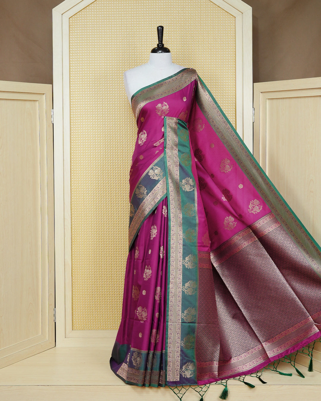 Magenta colour Mulberry silk saree featuring gold floral zari patterns on body, paired with contrast green colour with traditional border, comes with matching blouse piece.
