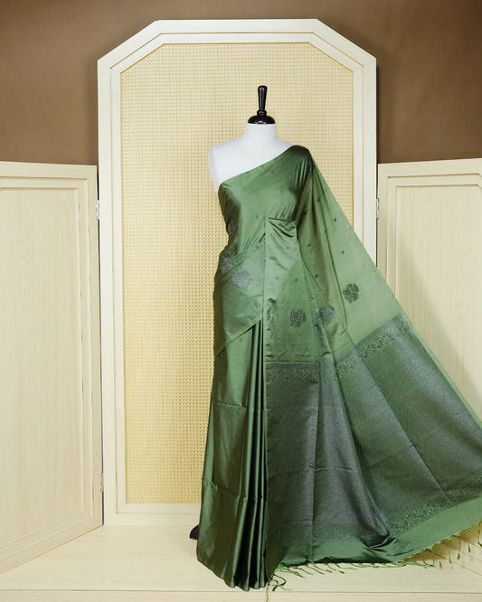 Pastel green colour soft silk saree featuring antique zari motifs on body with contrast self colour pallu & paired with matching blouse piece.