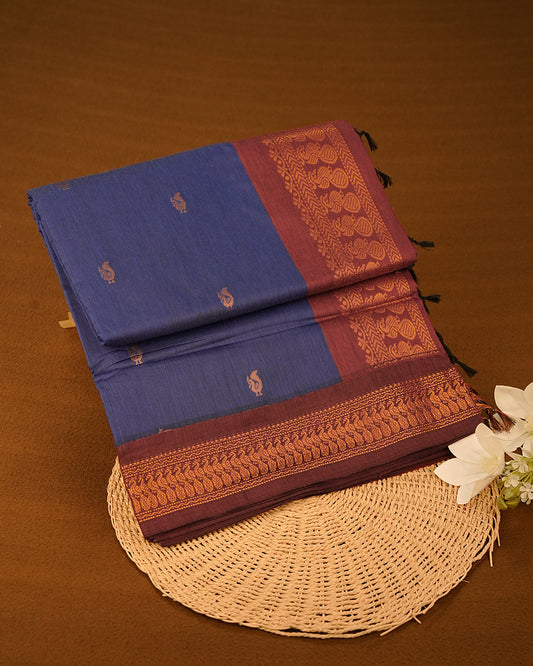 Navy Blue Colour Kalyani cotton saree featuring elegant antique zari peacock butta motifs on the body, complemented by a Maroon contrast pallu with a rich antique zari border, paired with a matching blouse piece