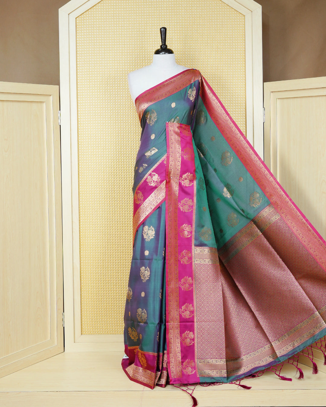 Green colour Mulberry silk saree featuring gold floral zari patterns on body, paired with contrast magenta colour with traditional border, comes with matching blouse piece.