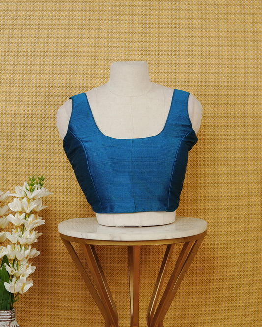 Blue colour Sleeveless Blouse Featuring A Classic Scoop Neck, Smooth Finish, And A Comfortable Tailored Fit.