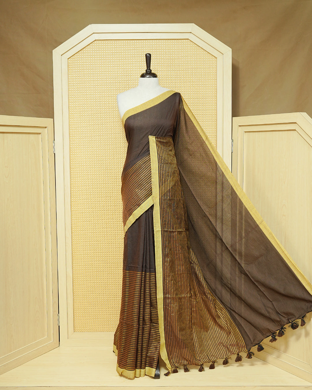 Dark Brown  Colour Mul Cotton Saree with a plain brown body, elegant Olive border, and striped pallu. Finished with a matching tassels