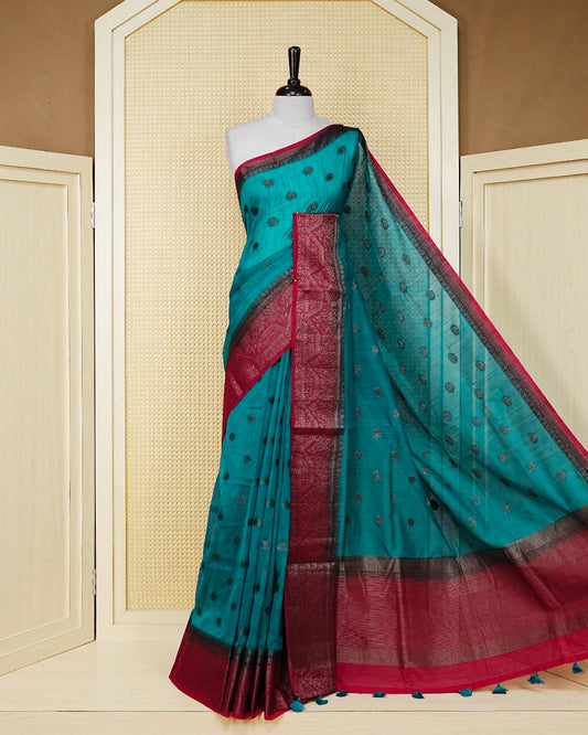 Dark teal colour semi linen saree thread motifs on body, contrast dark pink colour gold zari border, rich pallu comes with matching blouse piece