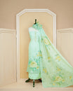 Pastel Green Linen Salwar Material featuring beadwork on the neck yoke, mirror work, and floral prints, paired with a matching bottom and dupatta.