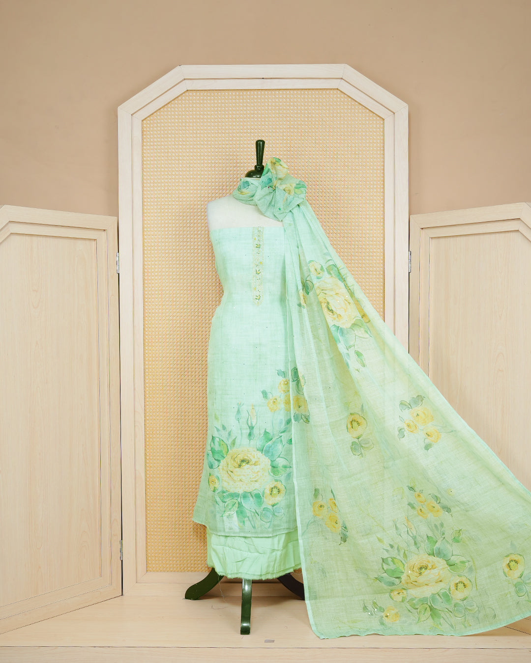 Pastel Green Linen Salwar Material featuring beadwork on the neck yoke, mirror work, and floral prints, paired with a matching bottom and dupatta.