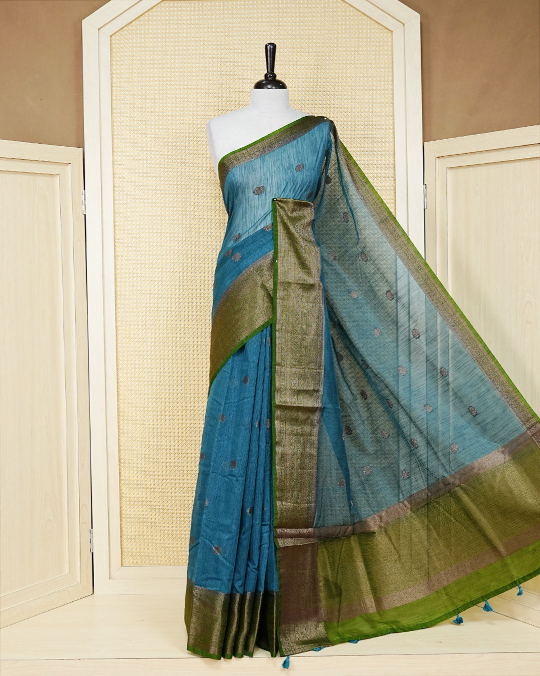 Dark teal colour semi linen saree thread motifs on body, contrast mehndi green colour gold zari border, rich pallu comes with matching blouse piece