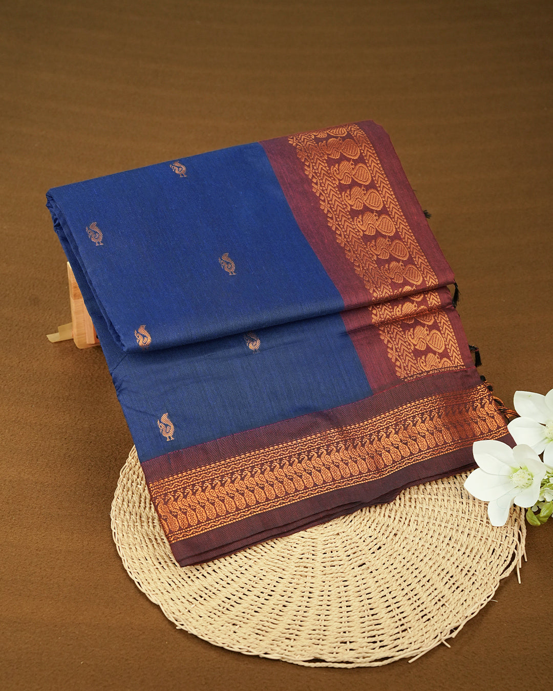 Dark Blue Colour Kalyani cotton saree featuring elegant antique zari peacock butta motifs on the body, complemented by a Maroon contrast pallu with a rich antique zari border, paired with a matching blouse piece