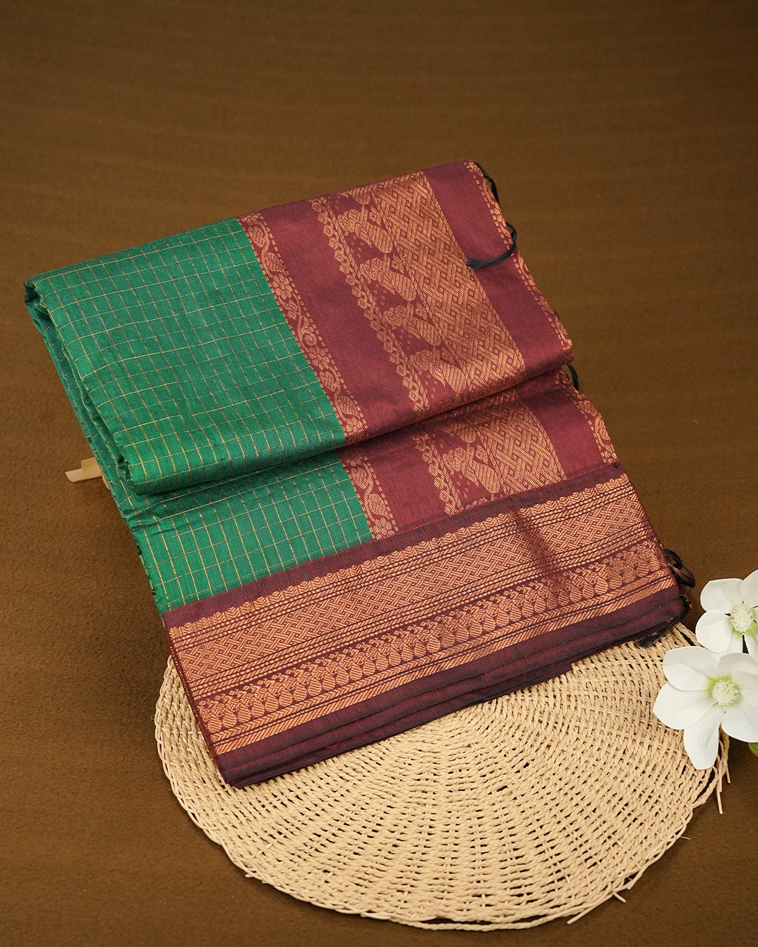 Green Colour Kalyani Cotton Saree Featuring Copper Zari Check Pattern On Body, Complemented By Maroon Colour With Antique Zari Border,Paired With Matching Blouse Piece.