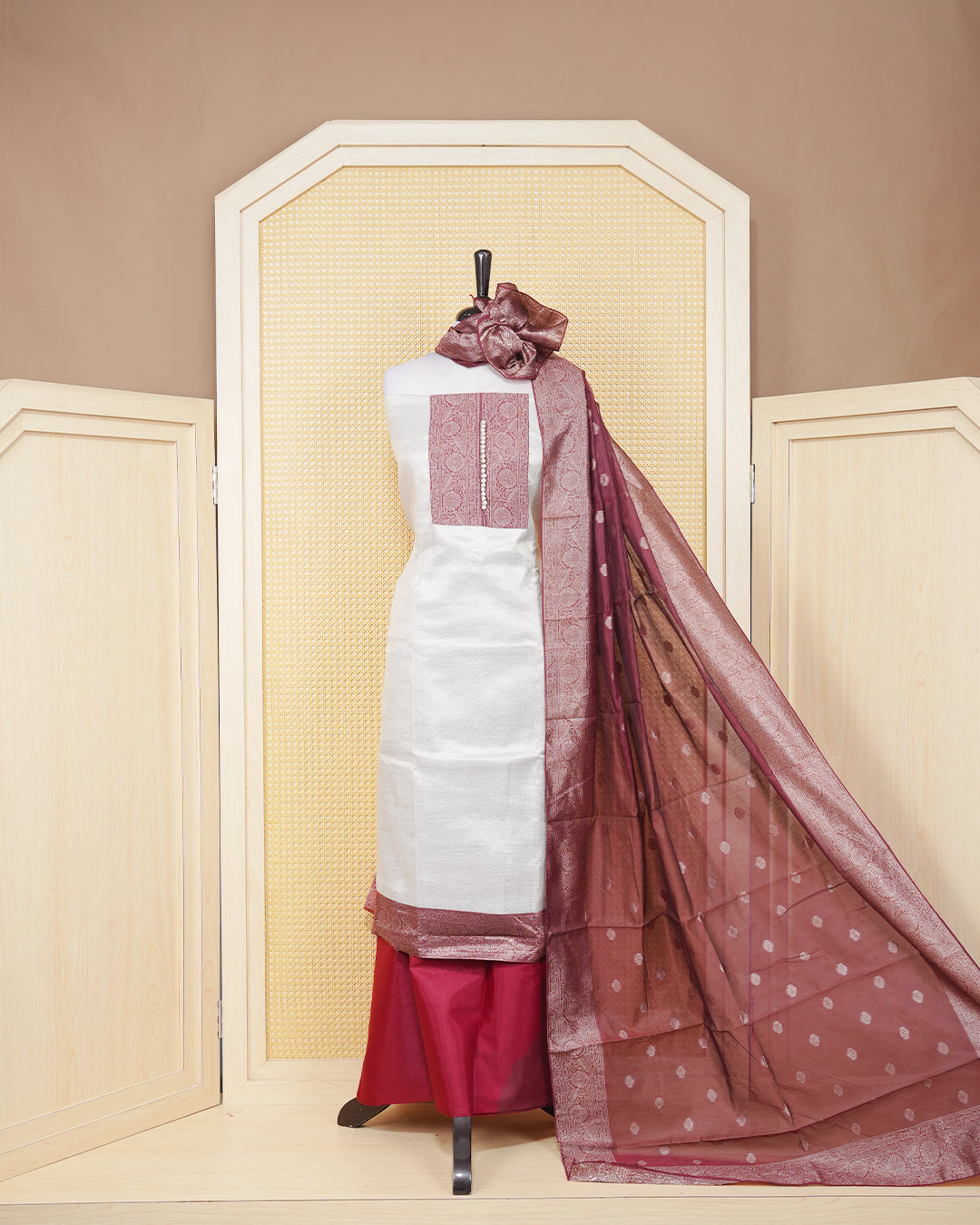 Cream colour tissue salwar material featuring plain body ,maroon colour with floral work on chest portion, Paired With a Matching Bottom and an Elegant Dupatta.