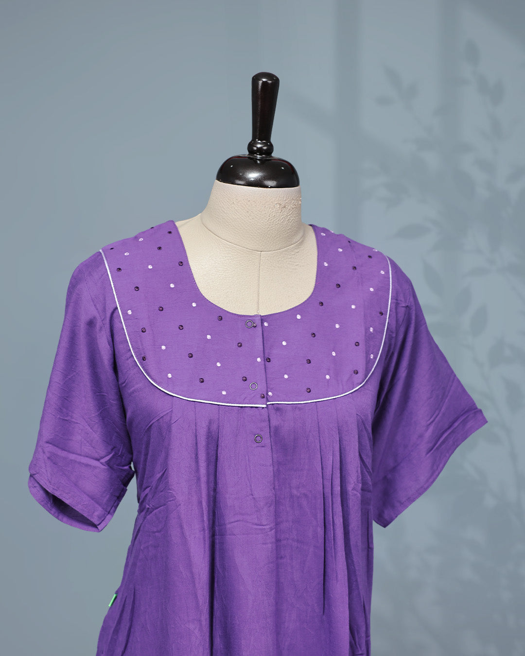 Elegant solid purple nighty featuring a round neckline with embellished yoke, delicate contrast piping, front button placket & half sleeve and a relaxed full-length fit for all-day comfort and graceful everyday wear.