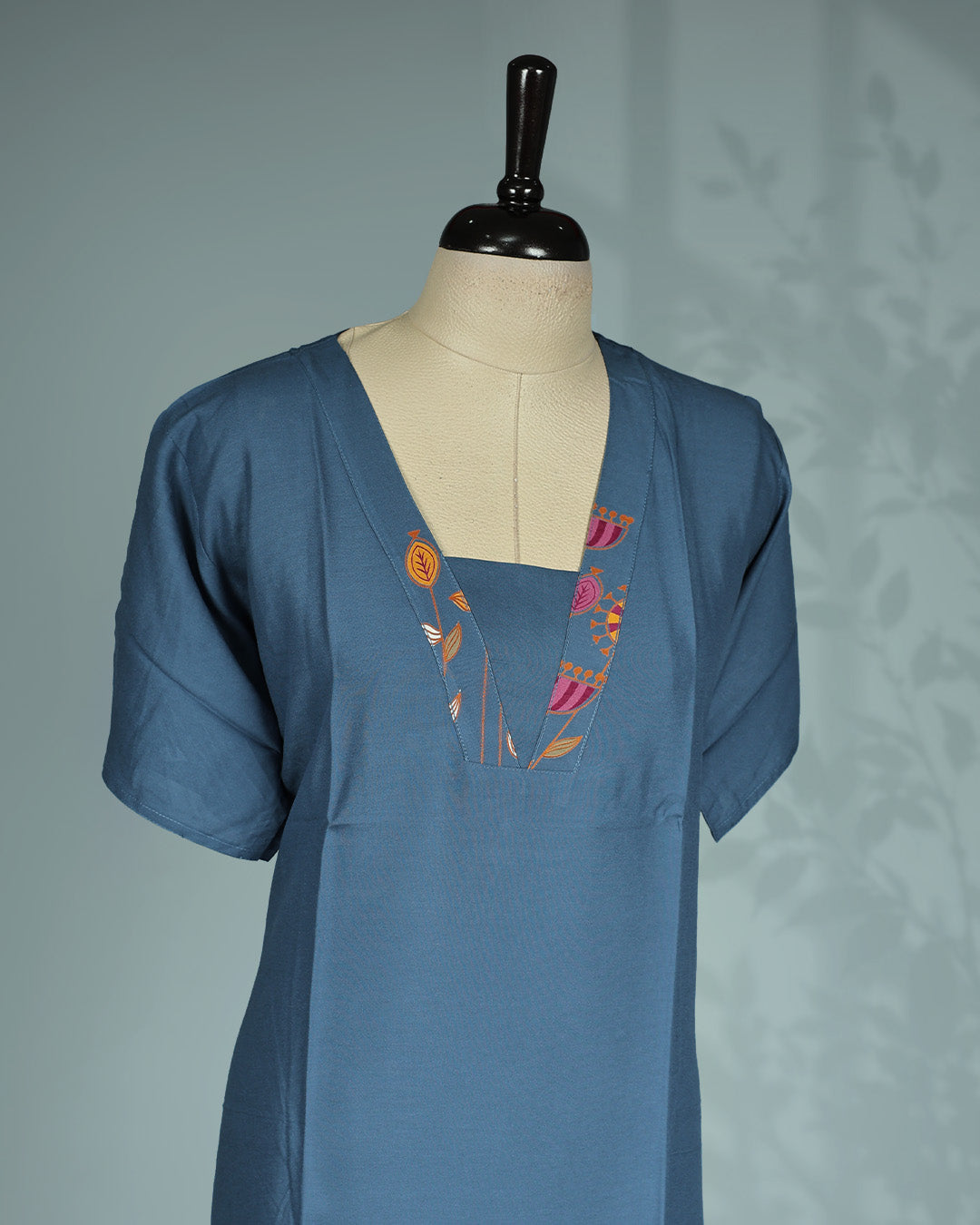 Elegant slate blue solid nighty featuring a stylish V-notch neckline with colourful floral embroidery, short sleeves and a comfortable Mid-length relaxed fit