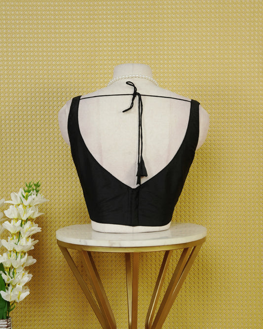 Black Colour Plain Blouse Featuring A Simple Boat Neckline, Sleeveless Design, And A Clean Fitted Silhouette.