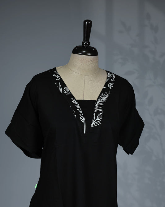 Black colour nighty featuring white floral prints on the V-neckline and hem, short sleeves and a mid-length fit.
