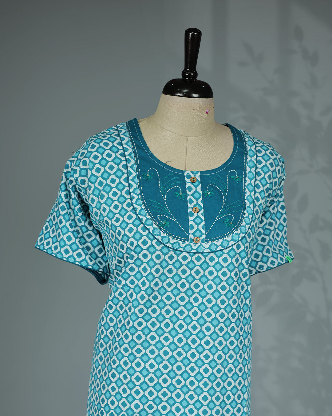 Light Blue Colour printed nighty featuring a stylish contrast embroidered yoke with decorative wooden buttons, a classic round neckline, short sleeves and a relaxed full-length fit for breathable comfort and everyday elegance.