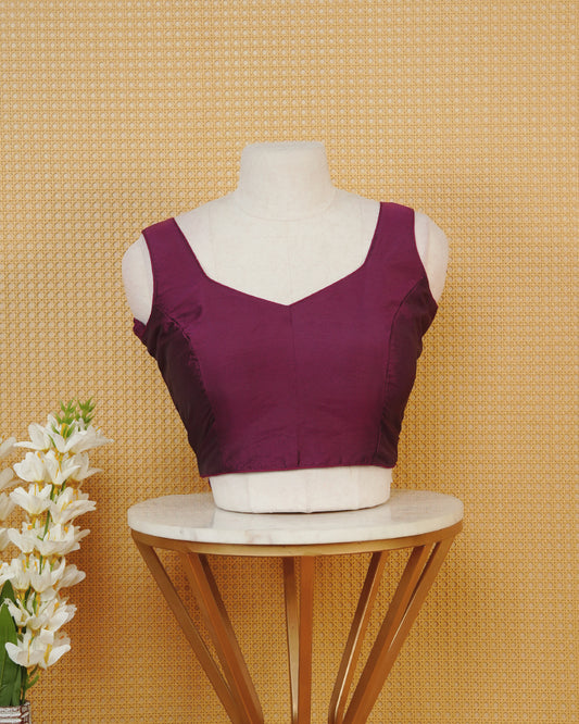 Burgundy colour Sleeveless Blouse Featuring A Stylish Sweetheart Neck, Smooth Finish, And A Comfortable Tailored Fit.