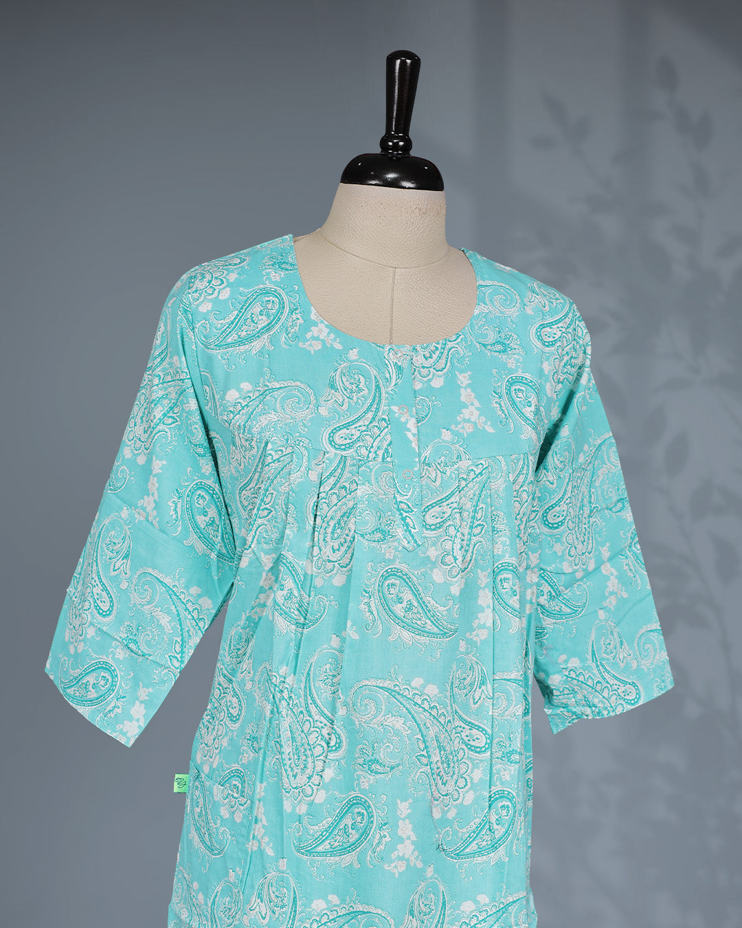 Aqua blue colour printed nighty featuring a classic round neckline With Openable Button, three-quarter sleeves and a relaxed full-length silhouette for breathable comfort and effortless everyday wear.