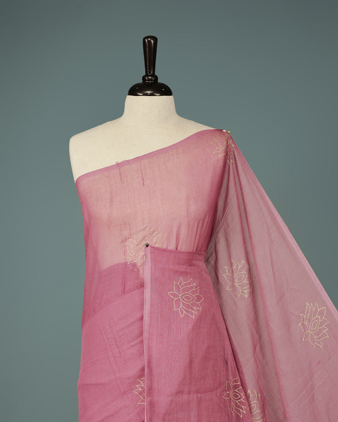 Onion colour pure mul cotton saree featuring Minimal Lotus Print on body, Clean Borderless design, elegant tassels.
