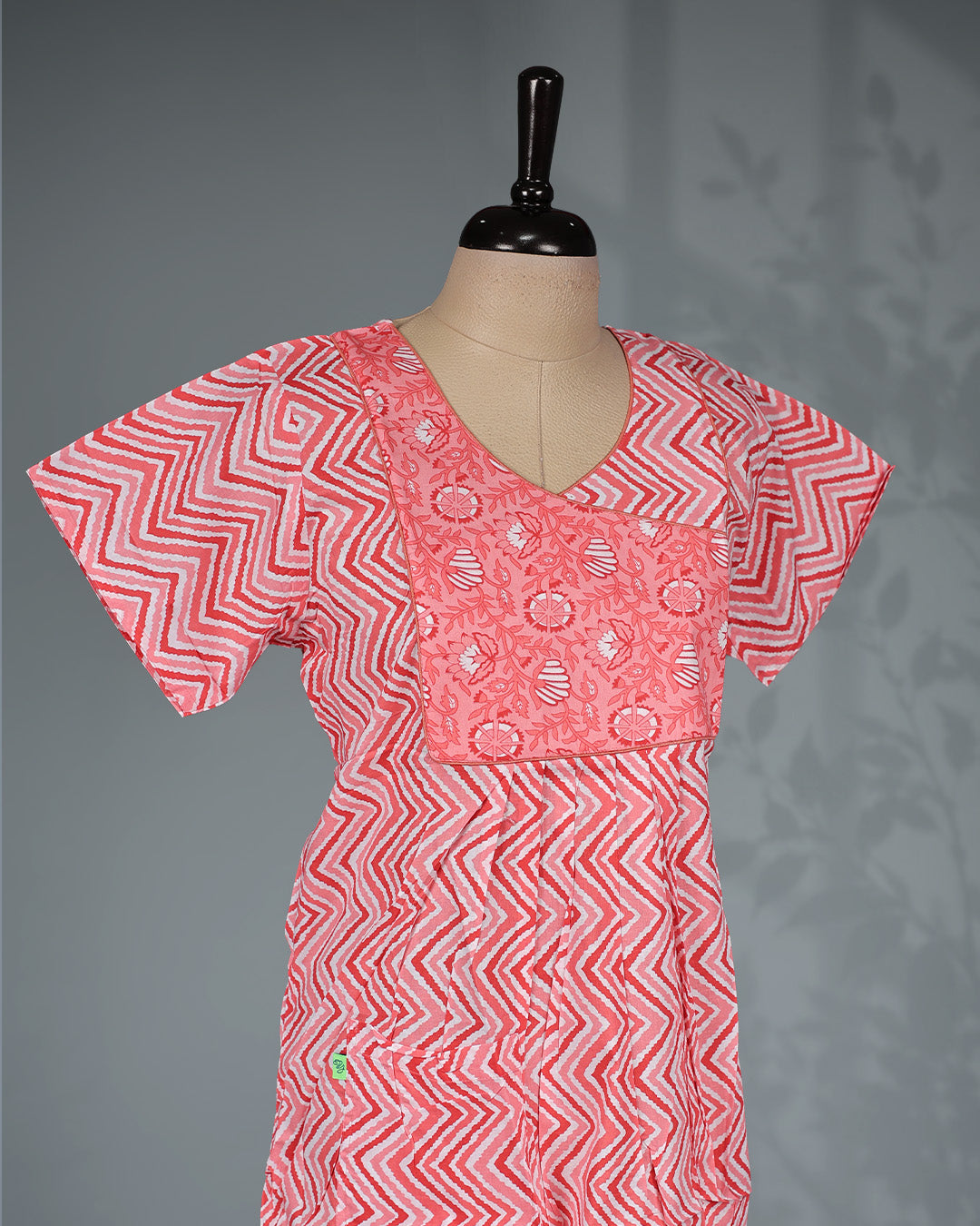 Light Red colour printed nighty with a stylish contrast asymmetrical yoke, V-neckline, short sleeves and a relaxed full-length silhouette for comfortable everyday wear with a modern touch.