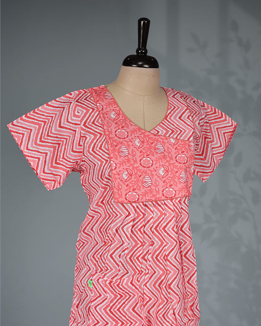Light Red colour printed nighty with a stylish contrast asymmetrical yoke, V-neckline, short sleeves and a relaxed full-length silhouette for comfortable everyday wear with a modern touch.